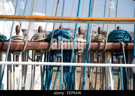 Ropes on belaying pins on board a sailing ship Stock Photo