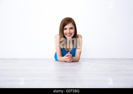 Portrait of a beautiful smiling woman lying on the floor Stock Photo