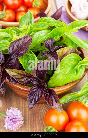 Fresh farmers tomatoes and basil on wood table with copy space Stock ...