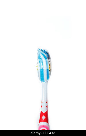 Red toothbrush with blue two color toothpaste on light surface. Photo of dental hygiene and health maintenance. Object isolated  Stock Photo