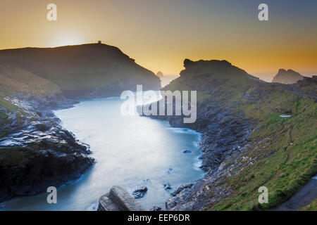 Sunset over the harbour entrance at Boscastle on the North Cornwall Coast England UK Europe