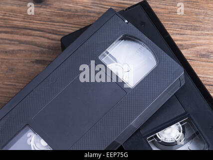 Image shows two old retro video tapes on a wooden table Stock Photo