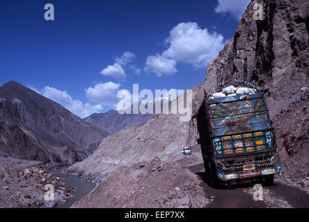 Karakorum Highway in Pakistan, a painted and decorated truck fills the road in Himalayas on road to northern areas and Skardu Stock Photo