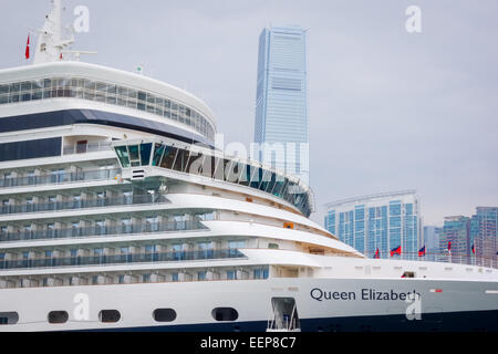 Cunard's Queen Elizabeth cruise ship docked in Hong Kong with the International Commerce Center ICC in the background Stock Photo