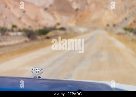 4WD car on the road in the desert, Middle East Stock Photo
