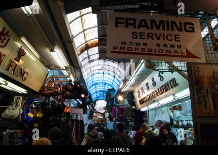 Busy market stalls and advertising signs in Stanley Market, Hong Kong Island, China Stock Photo