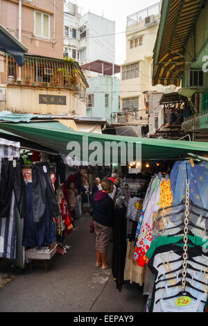 People and market stalls with clothes in Stanley Market, Hong Kong Island, China Stock Photo