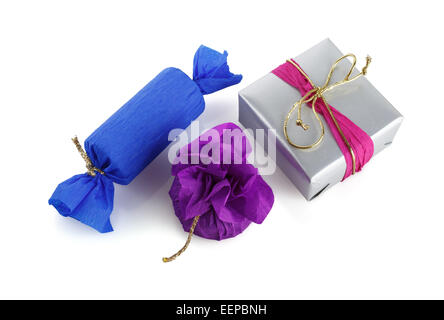 Three bright multi-colored gift boxes on a white background. Isolated with clipping path. Top view. Stock Photo