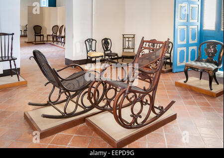 Room with antique wooden rocking chairs in the Colonial Art Museum (Museo del Arte Colonial) in Cathedral Square, Havana, Cuba Stock Photo