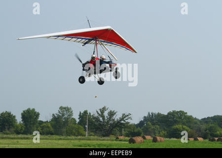 Accuracy contest of dropping a beanbag on a target. Adult man flying and adult woman with the beanbag.AIRBORNE WINDSPORTS model Stock Photo