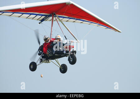 Accuracy contest of dropping a beanbag on a target. Adult man flying and adult woman with the beanbag.AIRBORNE WINDSPORTS model Stock Photo