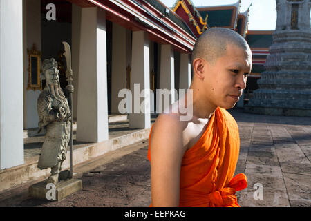 Buddhist monk inside Wat Pho Temple, Bangkok, Thailand. Wat Pho (the Temple of the Reclining Buddha), or Wat Phra Chetuphon, is Stock Photo