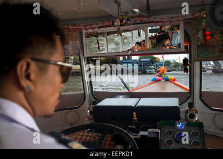 Chao Praya Express Boat driver. Bangkok, Inside public boat, ferry. Bangkok. Asia.  The Chao Phraya river makes a great way to g Stock Photo