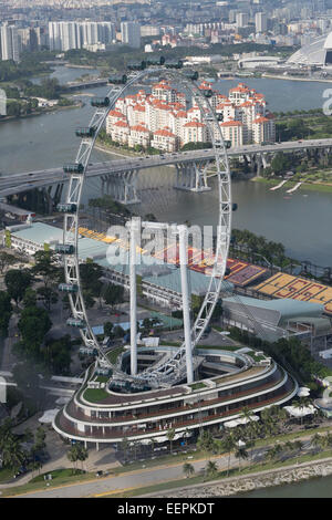 Singapore Flyer. Giant ferris wheel in Singapore. As seen from the Sky View Park of the Marina Bay Sands Hotel and Casino. Stock Photo