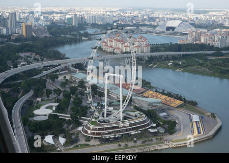 Singapore Flyer. Giant ferris wheel in Singapore. As seen from the Sky View Park of the Marina Bay Sands Hotel and Casino. Stock Photo