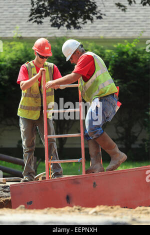 Two young men construction workers Stock Photo - Alamy