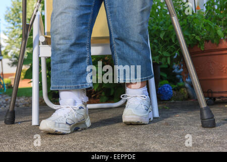 Woman with Spina Bifida about to walk with new leg brace and crutches Stock Photo