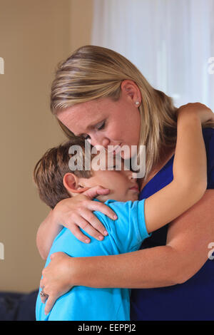 Mother and son with hearing impairments hugging Stock Photo