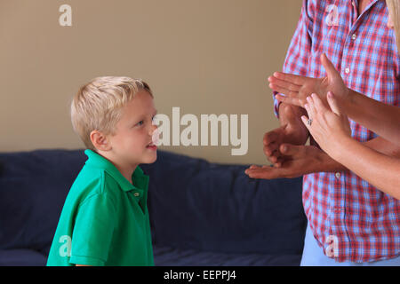 Parents and son with hearing impairments signing 'stop, timeout' in American sign language Stock Photo