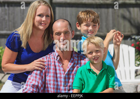 Portrait of a happy family with hearing impairments signing in American sign language Stock Photo