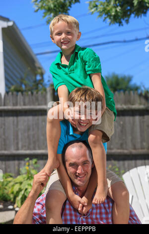Portrait of a happy family with hearing impairments playing in backyard Stock Photo