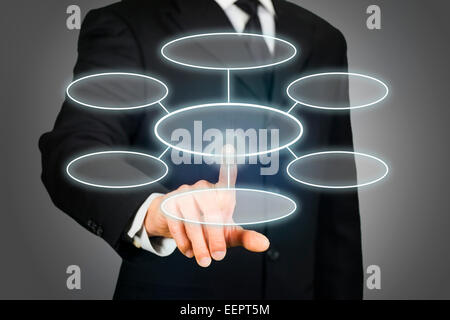 Businessman clicking flowchart on touchscreen Stock Photo