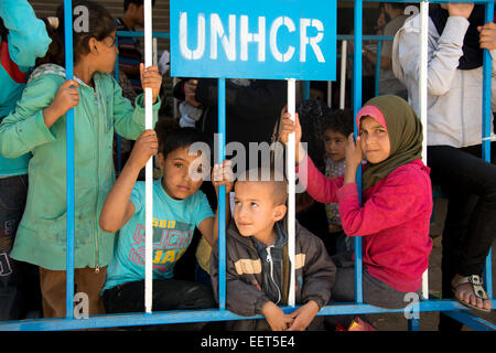 Syrian refugee children waiting to register at the UNHCR Stock Photo