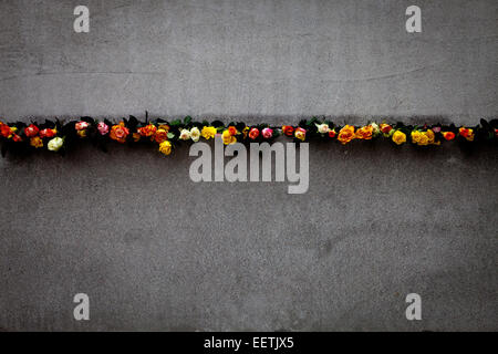 Flowers placed in the Berlin Wall during 25th commemoration of its fall Stock Photo