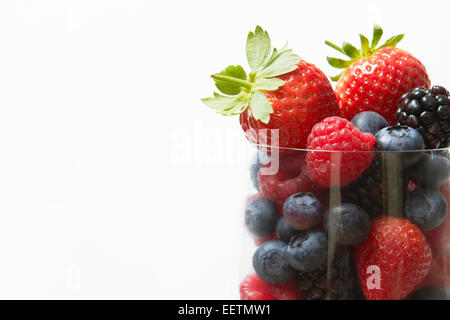 Selection Of Summer Fruits In Glass Against White Background Stock Photo