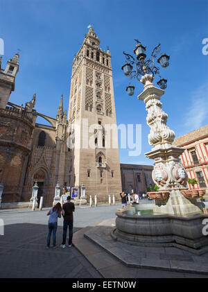 SEVILLE, SPAIN - OCTOBER 28, 2014: Cathedral de Santa Maria de la Sede with the Giralda bell tower from Plaze del Triumfo. Stock Photo