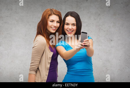 two smiling teenagers with smartphone Stock Photo