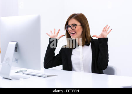 Portrait of a happy busiensswoman sitting at her workplace in office