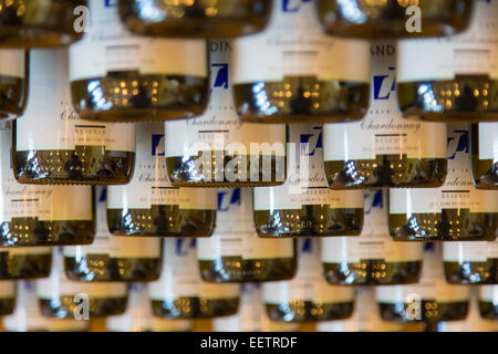 Wine bottles in rack in a winery in the Finger Lakes Region of New York State Stock Photo