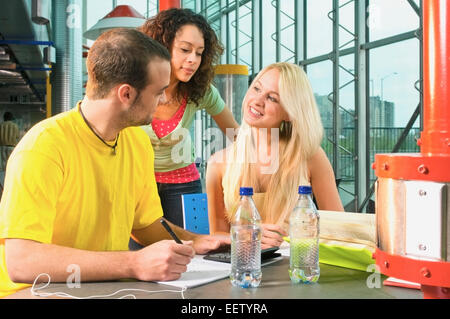College students working on assignments and studying together Stock Photo