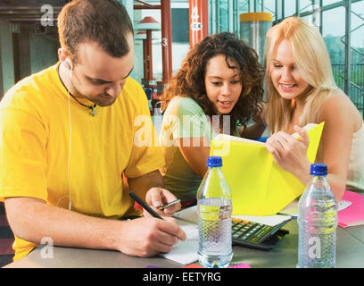 College students working on assignments and studying together Stock Photo