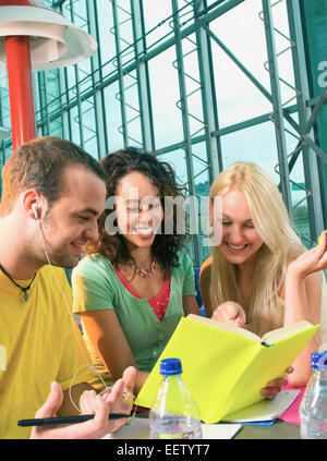 College students working on assignments and studying together Stock Photo