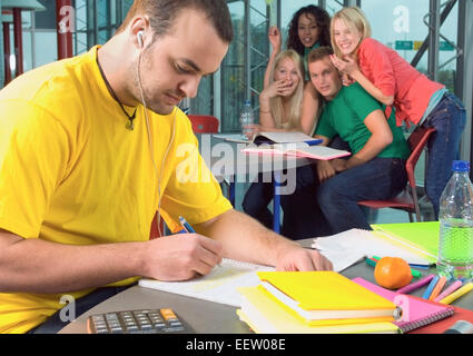 Male college student working on assignment Stock Photo