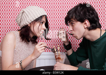 Young couple sharing an ice cream at ice cream parlor Stock Photo