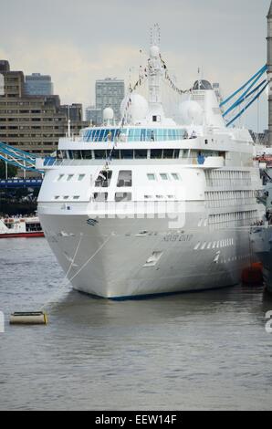 Cruiser ship moored alongside the HMS Belfast in London, England Stock Photo