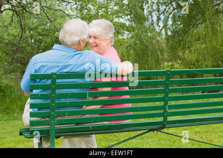 Senior couple sitting on bench Stock Photo