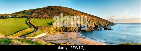 A panoramic view from the Southwest Coast Path as it passes Hemmick Beach near Gorran Haven on the south Cornwall coast Stock Photo