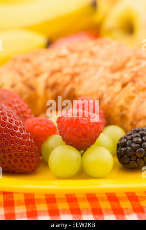Croissant pastry with fruit garnish Stock Photo