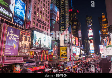 Times Square at Night. Times Square looking south with lots of bright lights, traffic and pedestrians everywhere. Stock Photo