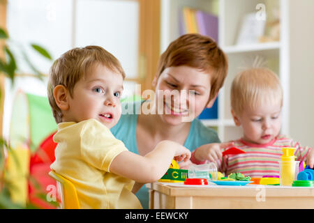 kids and mother playing colorful clay toy Stock Photo