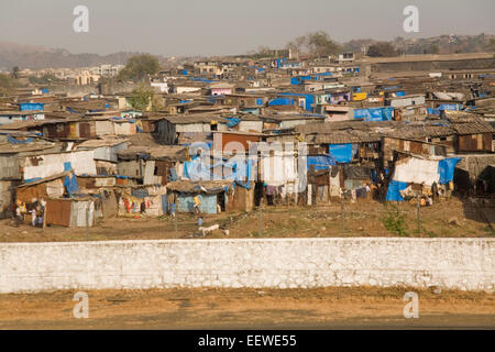 Shanty town in Mumbai or Bombay viewed from a taxiing aircraft at airport- marked contrasts Stock Photo