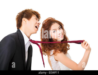 bride pulling on groom tie for control concept Stock Photo