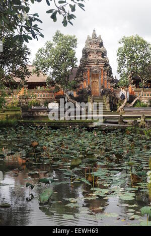 A lotus pond and Pura Taman Saraswati, a Hindu temple in Ubud, Bali. Stock Photo