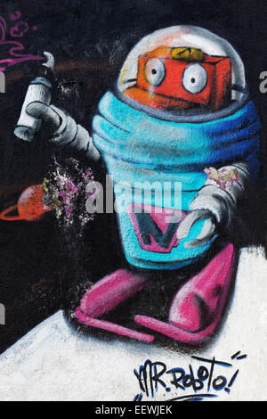 Robot in a space suit, holding spray can in hand, mural, street art, Duisburg, North Rhine-Westphalia, Germany Stock Photo