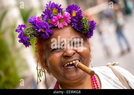 Elderly Cuban woman with flower headdress and cigar, Havana, Cuba Stock Photo