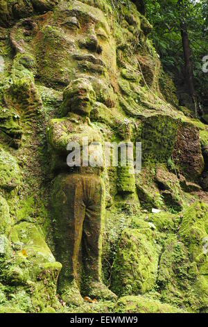 Moss covered rock sculptures in the gardens of Ayung Resort, Ubud, Bali. Stock Photo